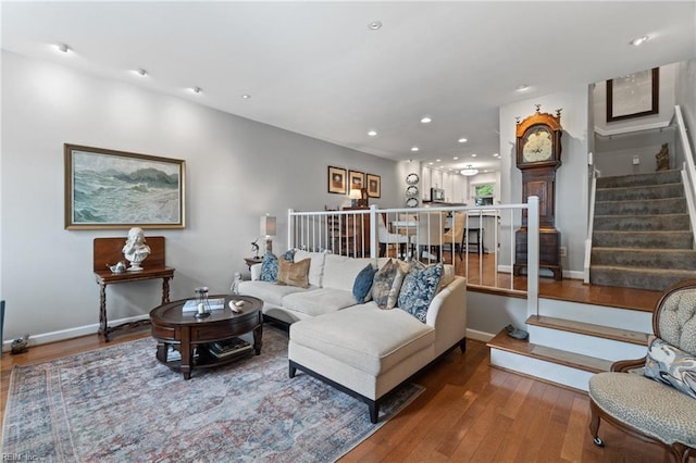 living room with hardwood / wood-style flooring, baseboards, stairway, and recessed lighting