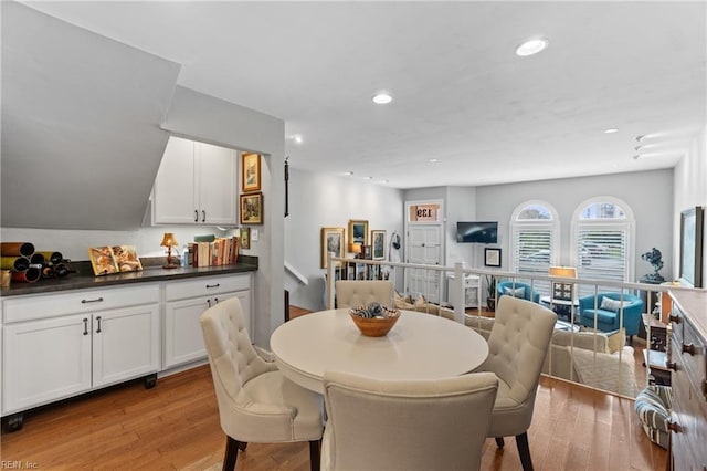 dining space with light wood-style floors and recessed lighting