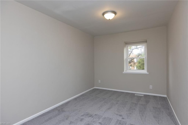 spare room with carpet floors and baseboards