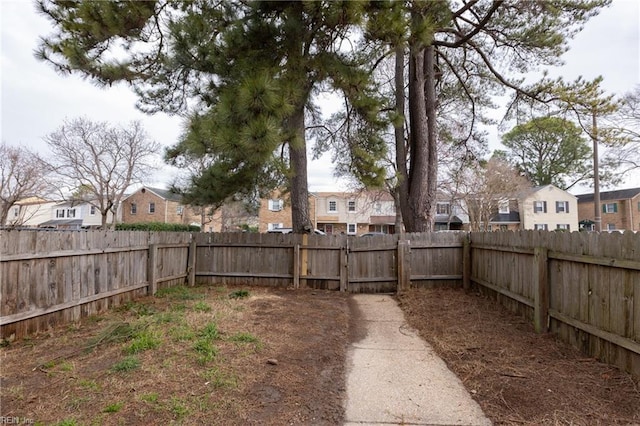 view of yard featuring a fenced backyard and a residential view