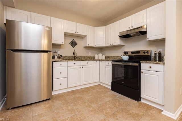 kitchen with under cabinet range hood, range with electric cooktop, white cabinetry, freestanding refrigerator, and dark stone countertops