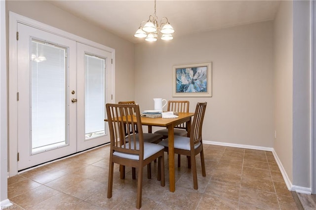 dining space featuring a chandelier, french doors, and baseboards