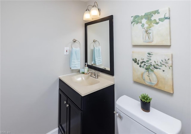 half bathroom featuring toilet and vanity