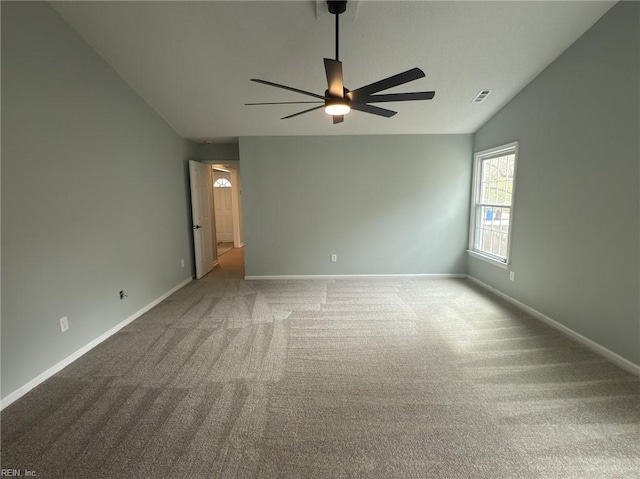 unfurnished room with lofted ceiling, carpet, baseboards, and visible vents