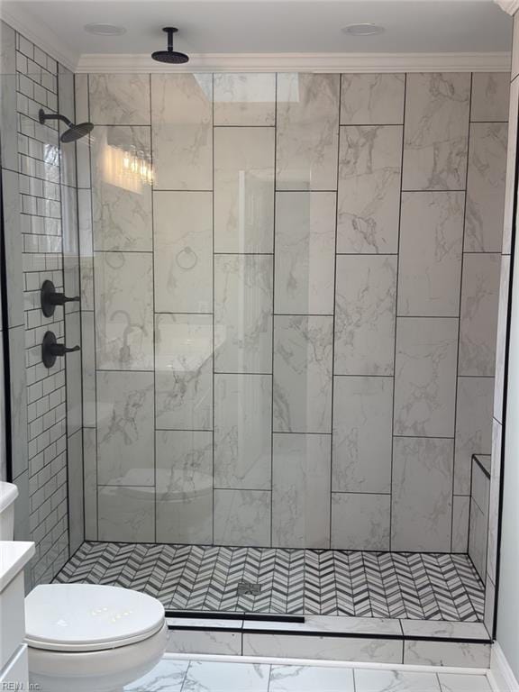 bathroom featuring a stall shower, marble finish floor, crown molding, and toilet