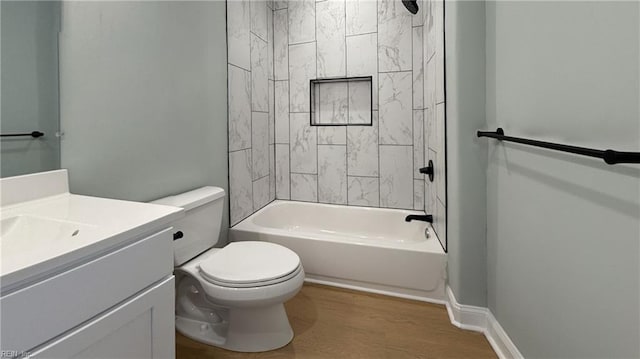 full bathroom featuring shower / bathing tub combination, toilet, vanity, wood finished floors, and baseboards