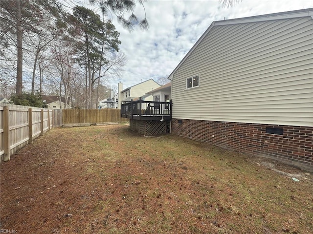 view of yard with a fenced backyard and a deck