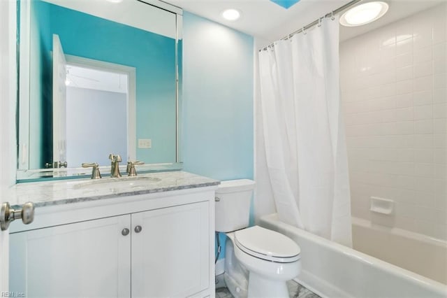 bathroom featuring toilet, shower / tub combo with curtain, and vanity