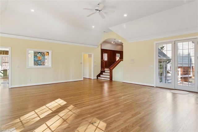 unfurnished living room featuring ceiling fan, ornamental molding, and arched walkways