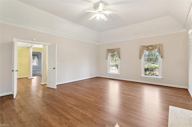 unfurnished room featuring baseboards, ceiling fan, a tray ceiling, and wood finished floors