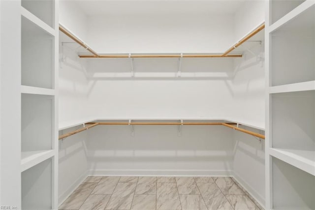 spacious closet with marble finish floor