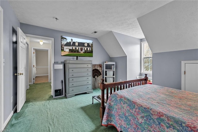 bedroom with lofted ceiling, carpet, visible vents, and a textured ceiling