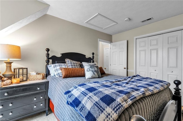 bedroom featuring lofted ceiling, light carpet, visible vents, a closet, and attic access