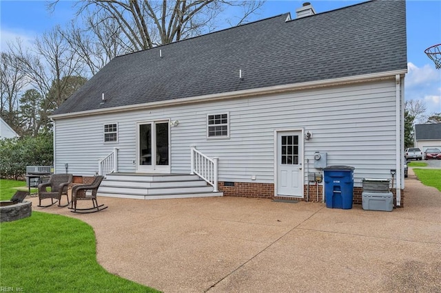 back of house featuring a chimney, roof with shingles, crawl space, and a patio area