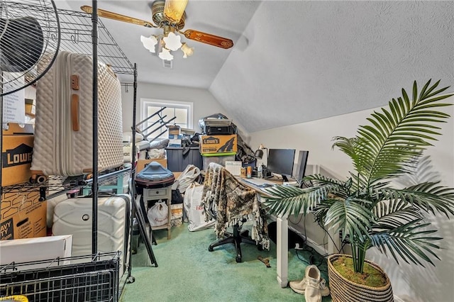 carpeted office featuring vaulted ceiling, a textured ceiling, and ceiling fan