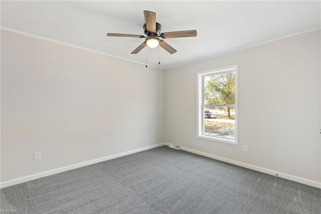 carpeted spare room with baseboards, visible vents, ornamental molding, and ceiling fan