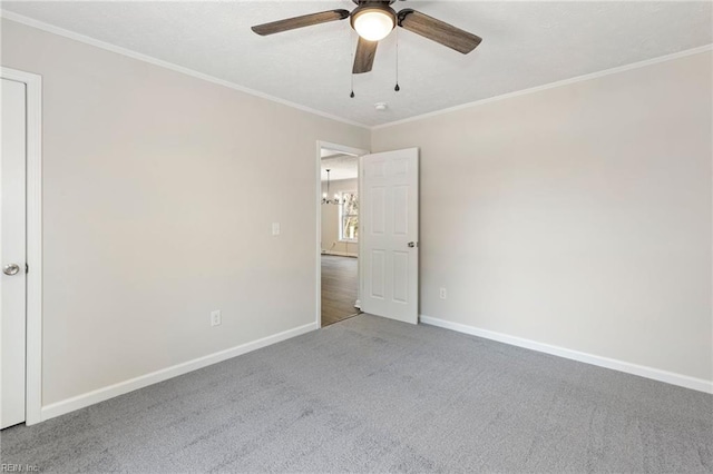 unfurnished bedroom featuring ceiling fan, carpet floors, ornamental molding, and baseboards