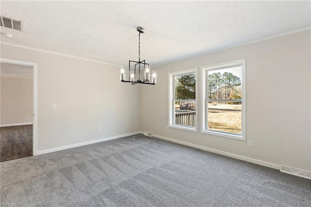 empty room with carpet floors, visible vents, crown molding, and a textured ceiling