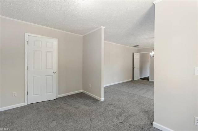 empty room with carpet floors, baseboards, ornamental molding, and a textured ceiling