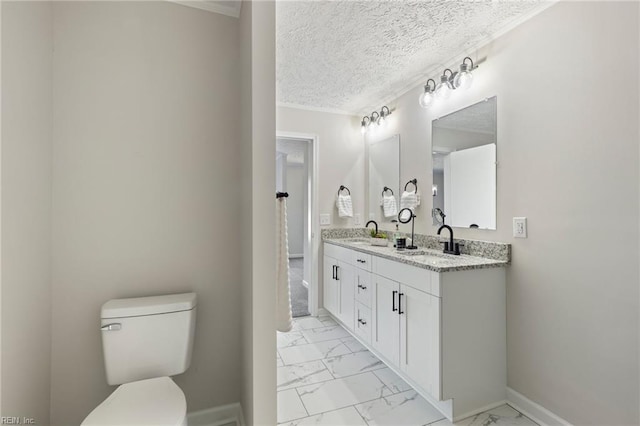 bathroom featuring marble finish floor, a sink, a textured ceiling, and toilet