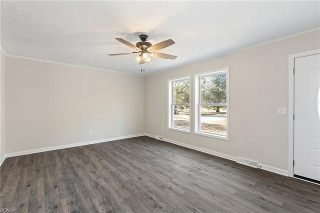 spare room featuring baseboards, visible vents, ceiling fan, dark wood-type flooring, and a textured ceiling