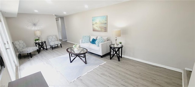 living room featuring recessed lighting, baseboards, and wood finished floors