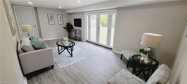 living area featuring recessed lighting, baseboards, wood finished floors, and french doors