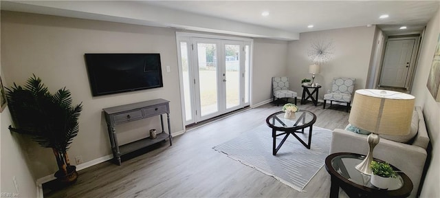 living room featuring baseboards, french doors, wood finished floors, and recessed lighting