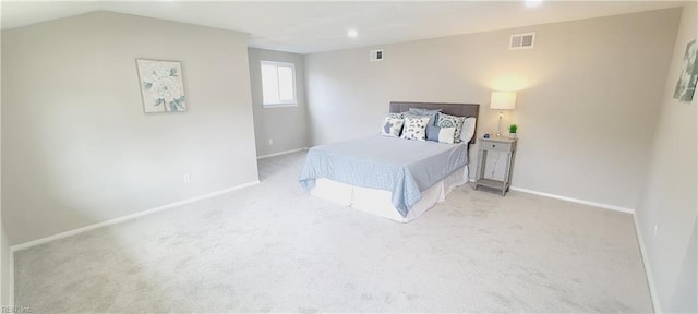 bedroom with baseboards, visible vents, and light colored carpet