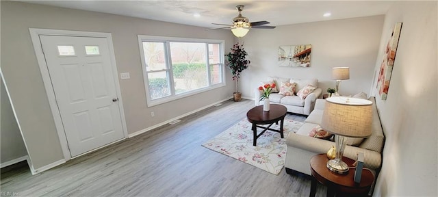 living area featuring recessed lighting, wood finished floors, a ceiling fan, and baseboards