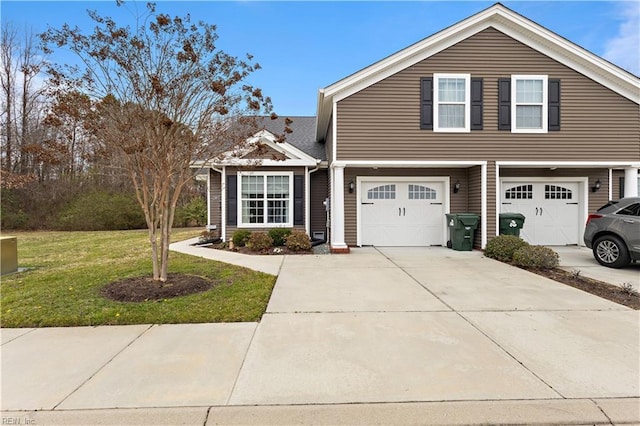 view of front of home with a garage, a front lawn, and concrete driveway