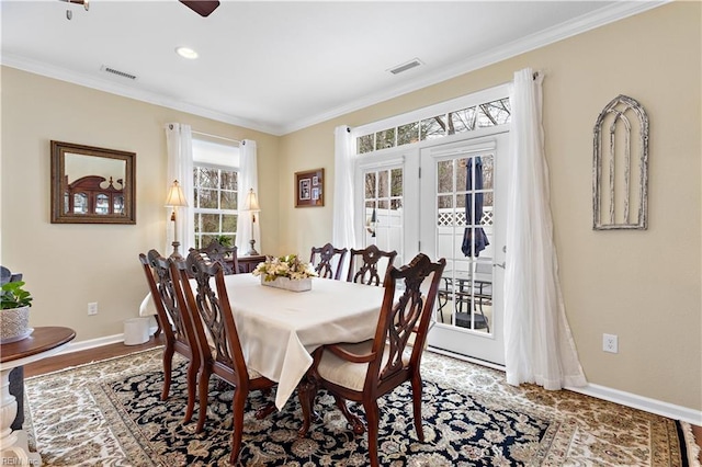 dining space with visible vents, ornamental molding, and baseboards