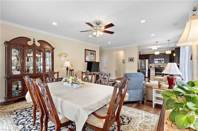 dining space with ornamental molding, recessed lighting, light wood-style flooring, and a ceiling fan