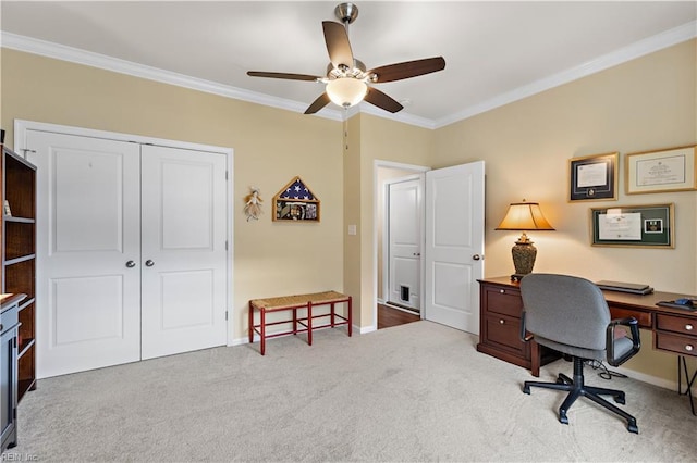 carpeted office with crown molding, baseboards, and ceiling fan