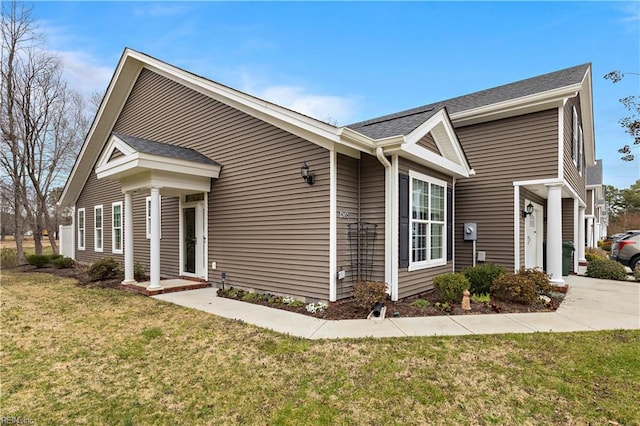 view of side of property with a yard