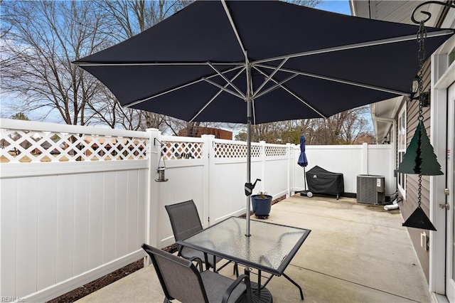 view of patio / terrace featuring a fenced backyard, cooling unit, and outdoor dining space