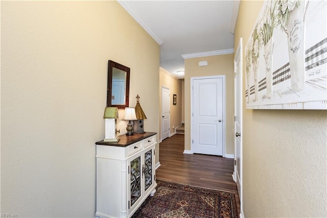 corridor featuring baseboards, dark wood finished floors, and crown molding