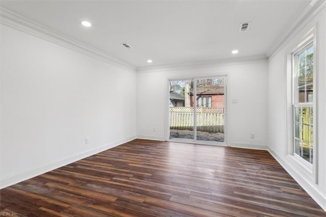 empty room with dark wood-style floors, ornamental molding, visible vents, and baseboards