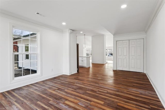 interior space featuring visible vents, ornamental molding, dark wood-type flooring, and recessed lighting