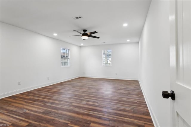 spare room featuring recessed lighting, dark wood-type flooring, visible vents, baseboards, and a ceiling fan