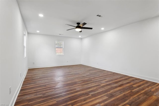 unfurnished room with dark wood-style floors, visible vents, a ceiling fan, and recessed lighting