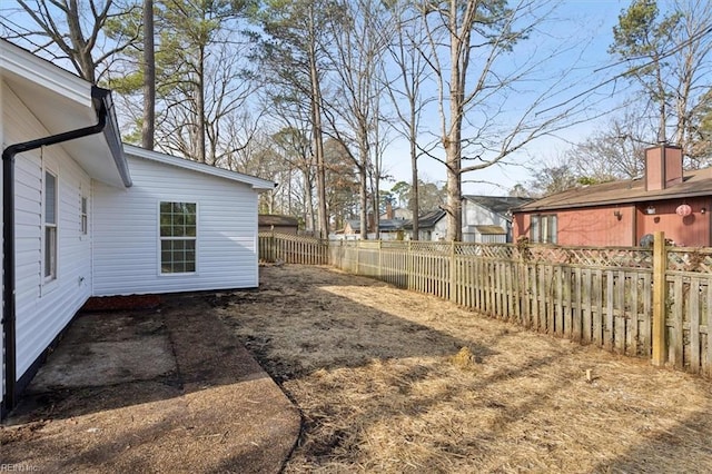 view of yard featuring a fenced backyard and a residential view