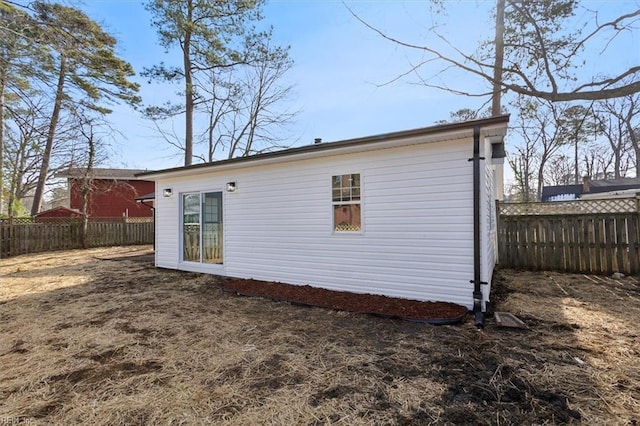 back of house featuring fence