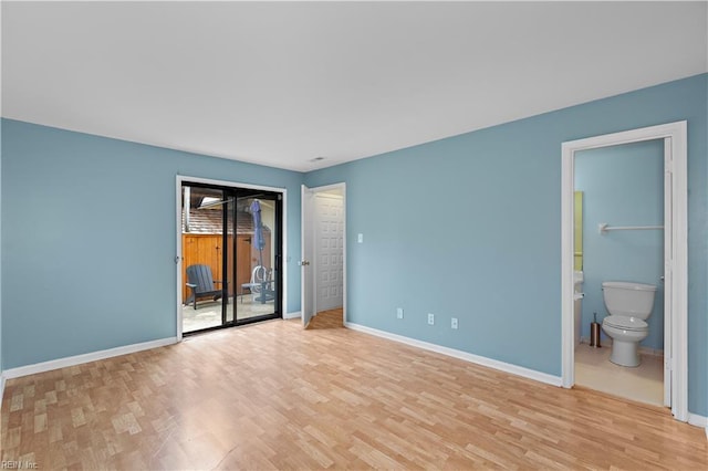 spare room featuring light wood finished floors and baseboards