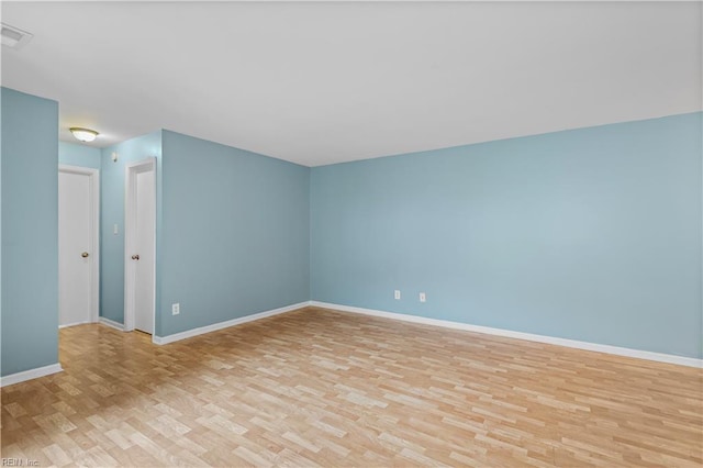 interior space with visible vents, light wood-style flooring, and baseboards