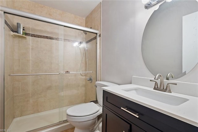 full bath with toilet, a stall shower, and vanity