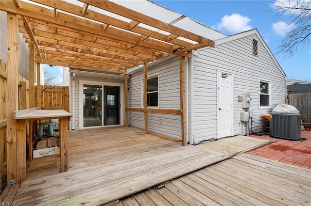 wooden terrace with fence, central AC unit, and a pergola