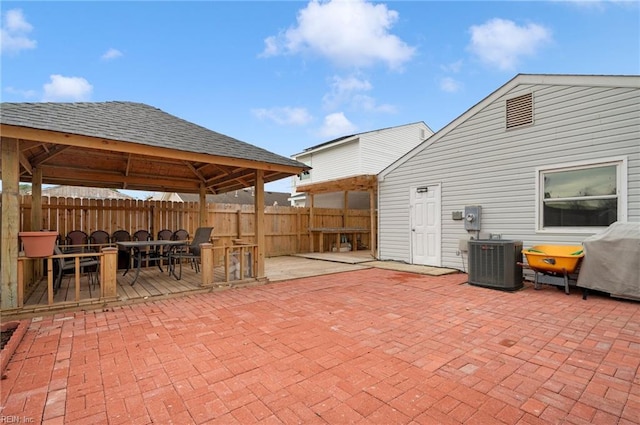 view of patio / terrace with fence, grilling area, a gazebo, and central AC unit