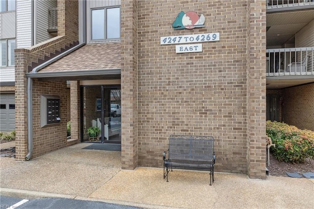 view of exterior entry with brick siding