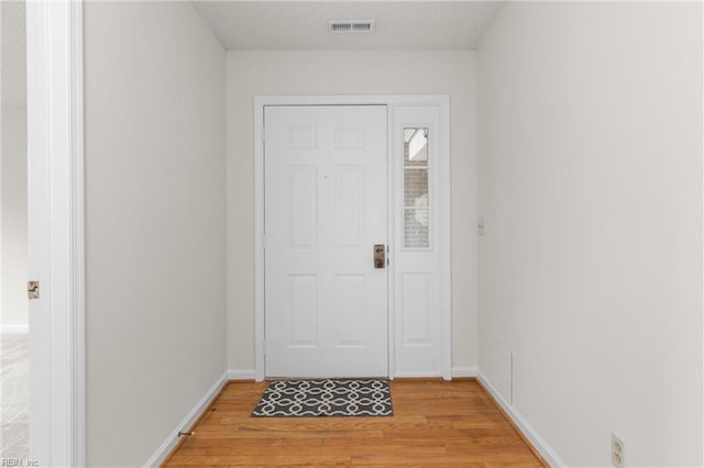 entryway featuring baseboards, visible vents, and light wood-style floors